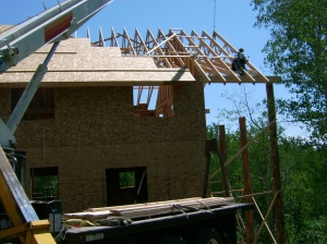 Setting the roof trusses on the deck overhang